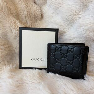 GUCCI Emblem bi-fold wallet in black GG leather